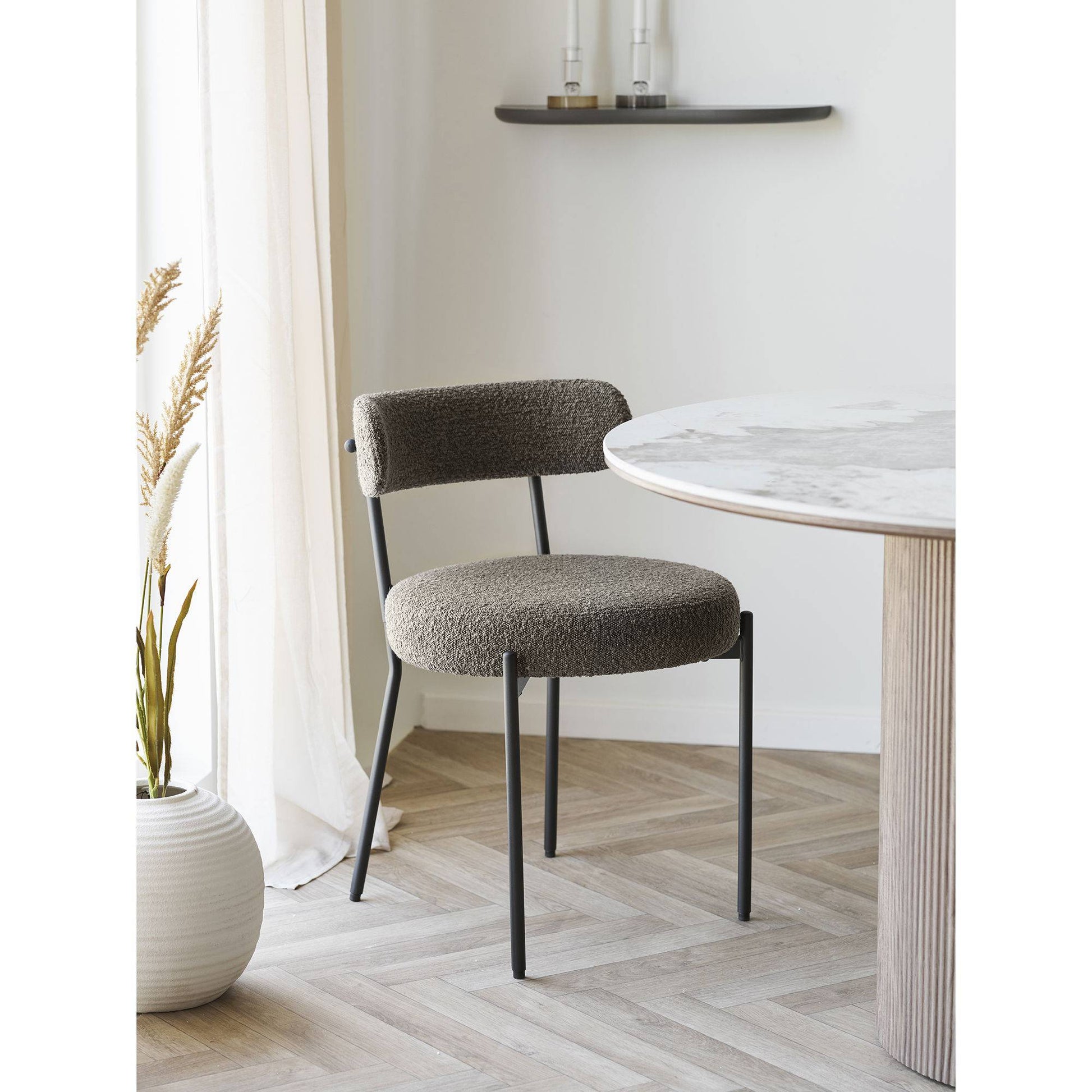 Scaun de dining din material bouclé, maro, picioare negre, in living bej